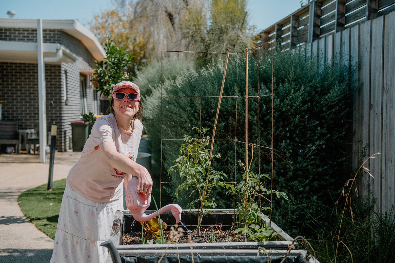 Linda watering the tomatoes
