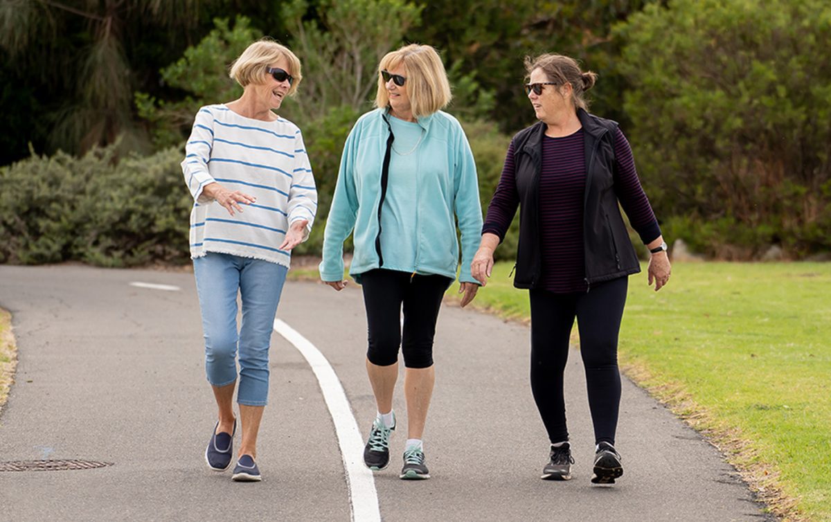 Three smiling women going for a walk