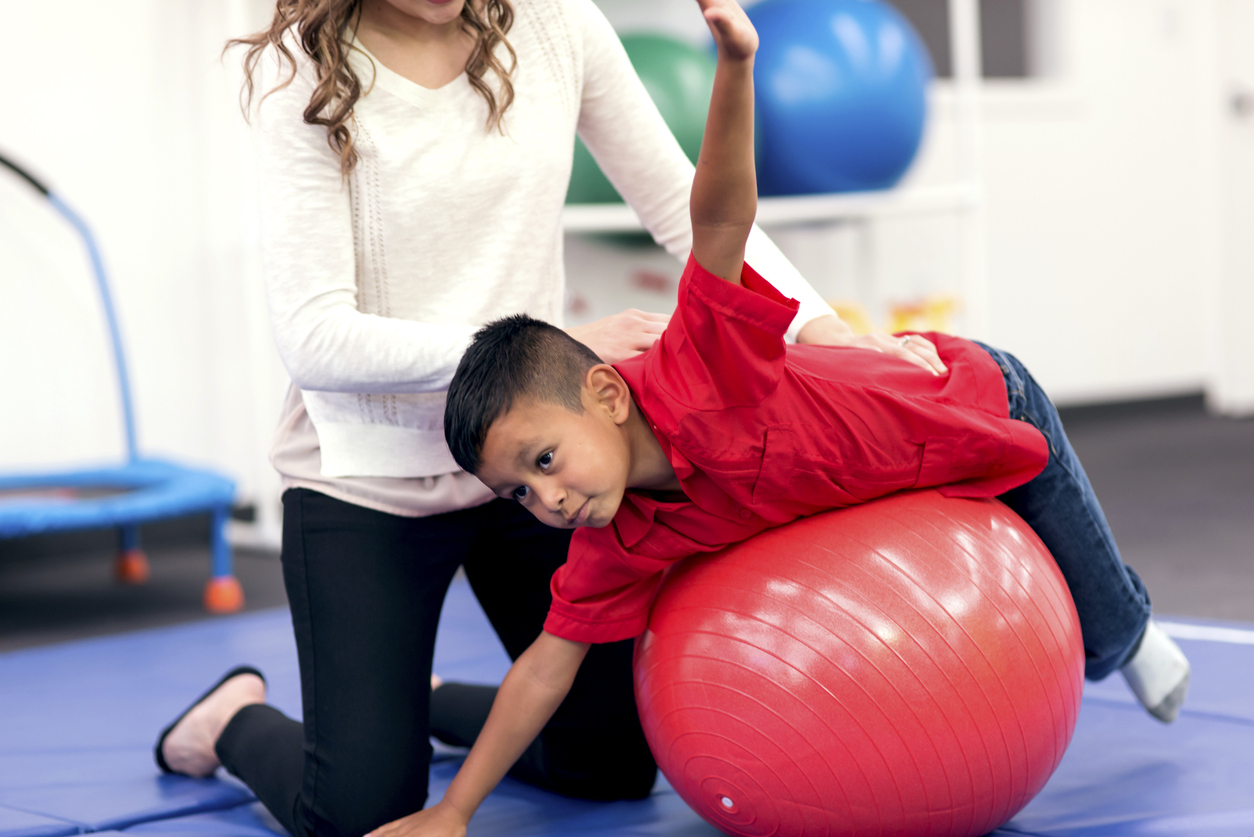 Child stretching on an exercise ball