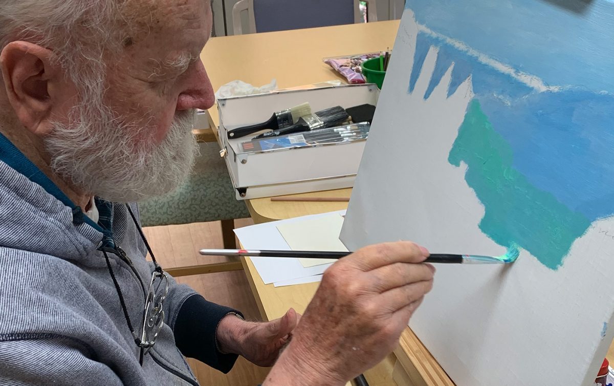 Aged care man painting at Costa House