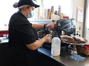 A woman using a coffee machine