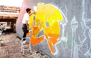 Person doing graffiti art