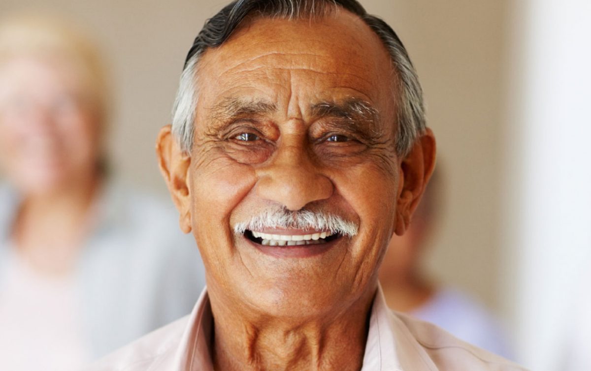 Aged care man smiling at camera