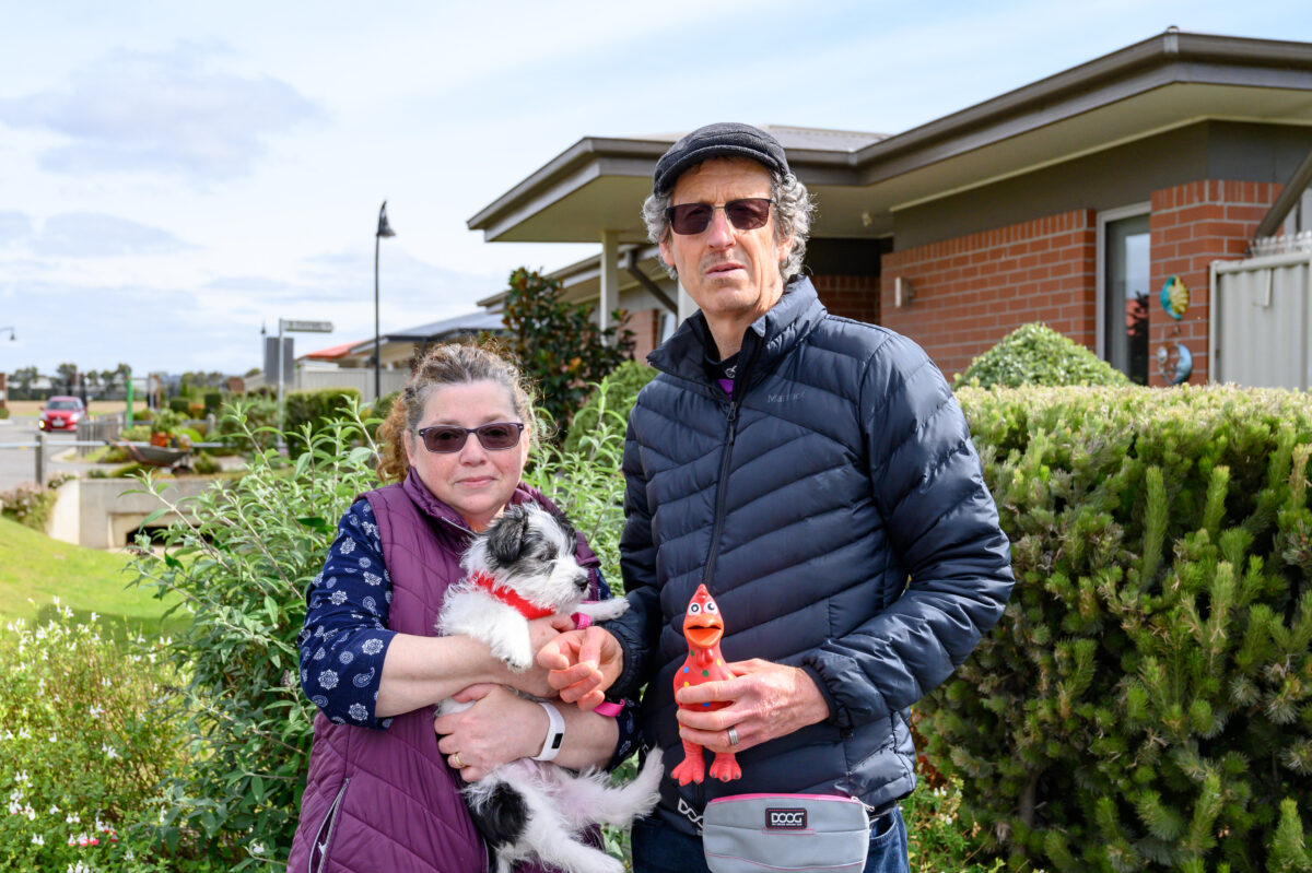 Barwarre Gardens residents Johanne and Andrew Tunne stand in front of units in garden.