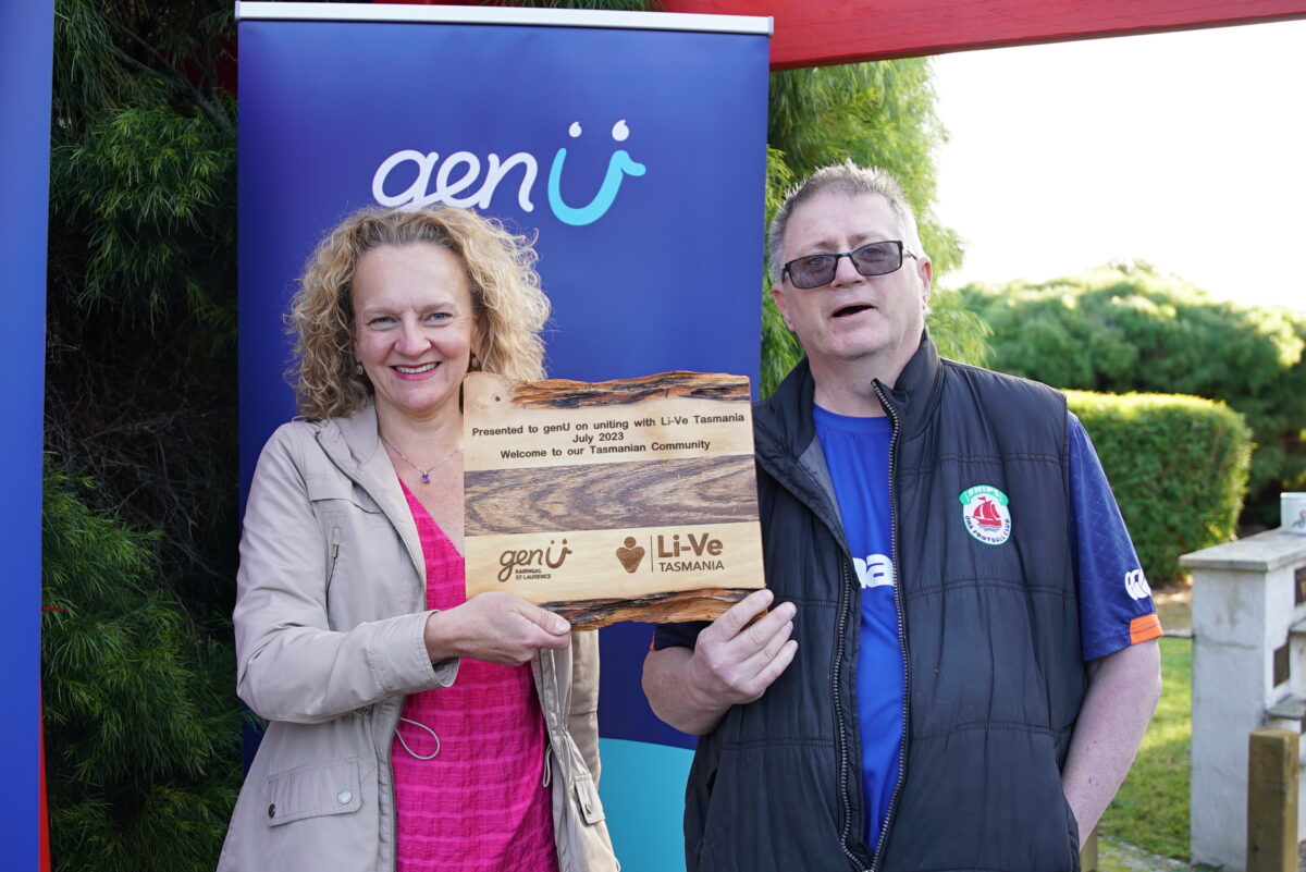 Clare Amies holds a handcrafted plaque made and presented by wood worker and Acquired Brain Injury prevention advocate, Alfred Archer, at Oakdale Lodge