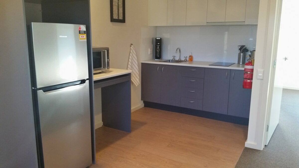 Small kitchen at Candlebark, Frankston SDA residential vacancy.